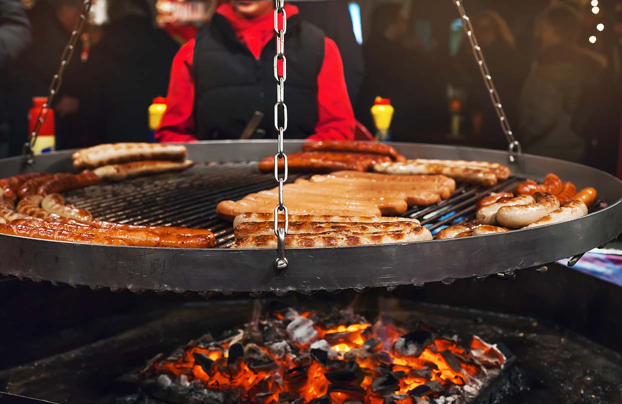 Grilling typical German sausages in the Christmas fair in Hamburg, image by tianalima, Shutterstock