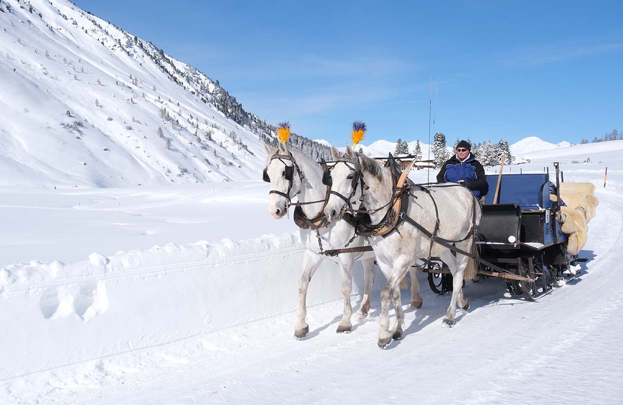 In true winter wonderland fashion indulge in a horse carriage ride in snow when at Davos Klosters, Image Copyright Marcel Giger